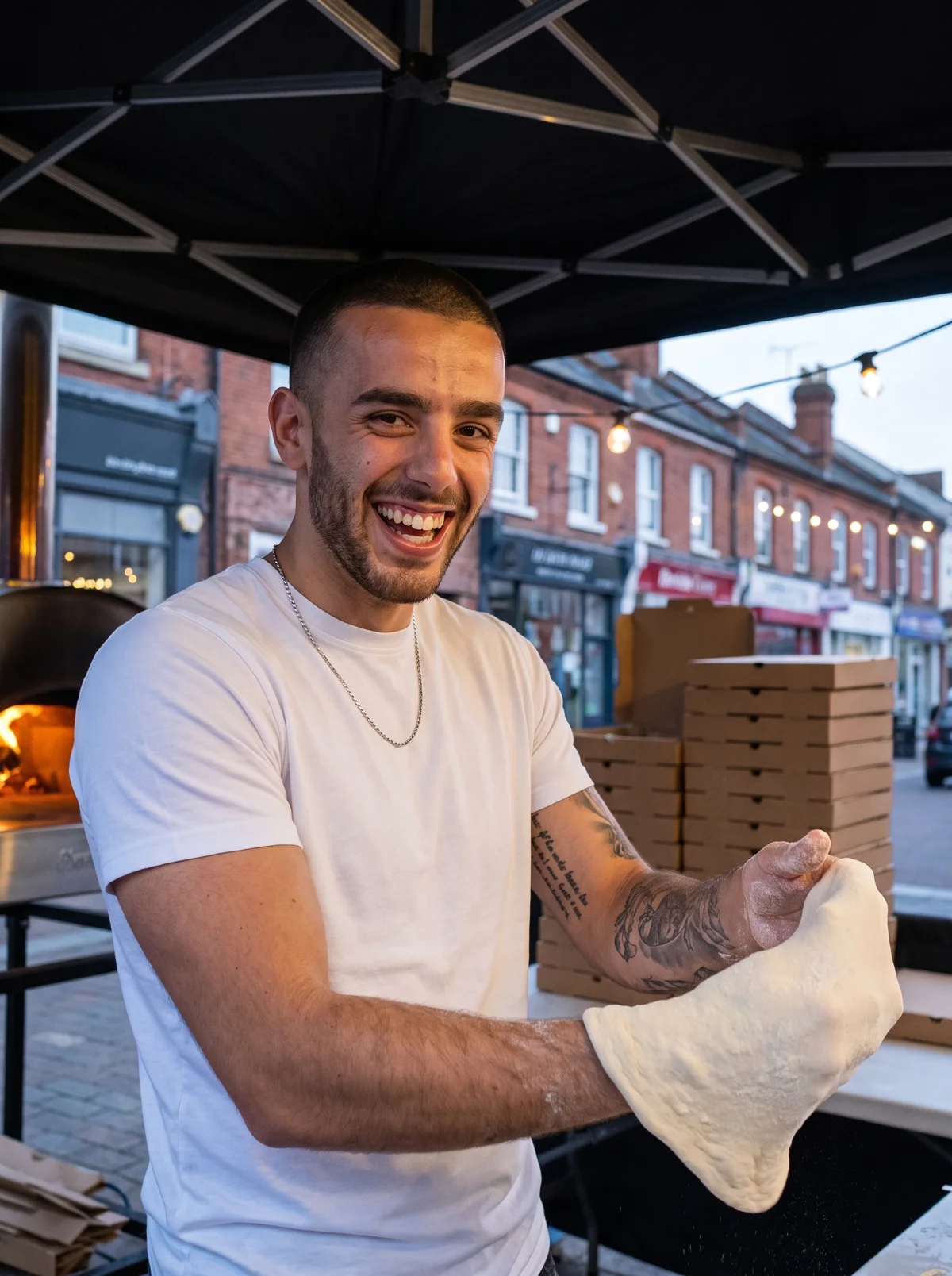Brad stretching dough under the Biga gazebo on a Wilmslow street